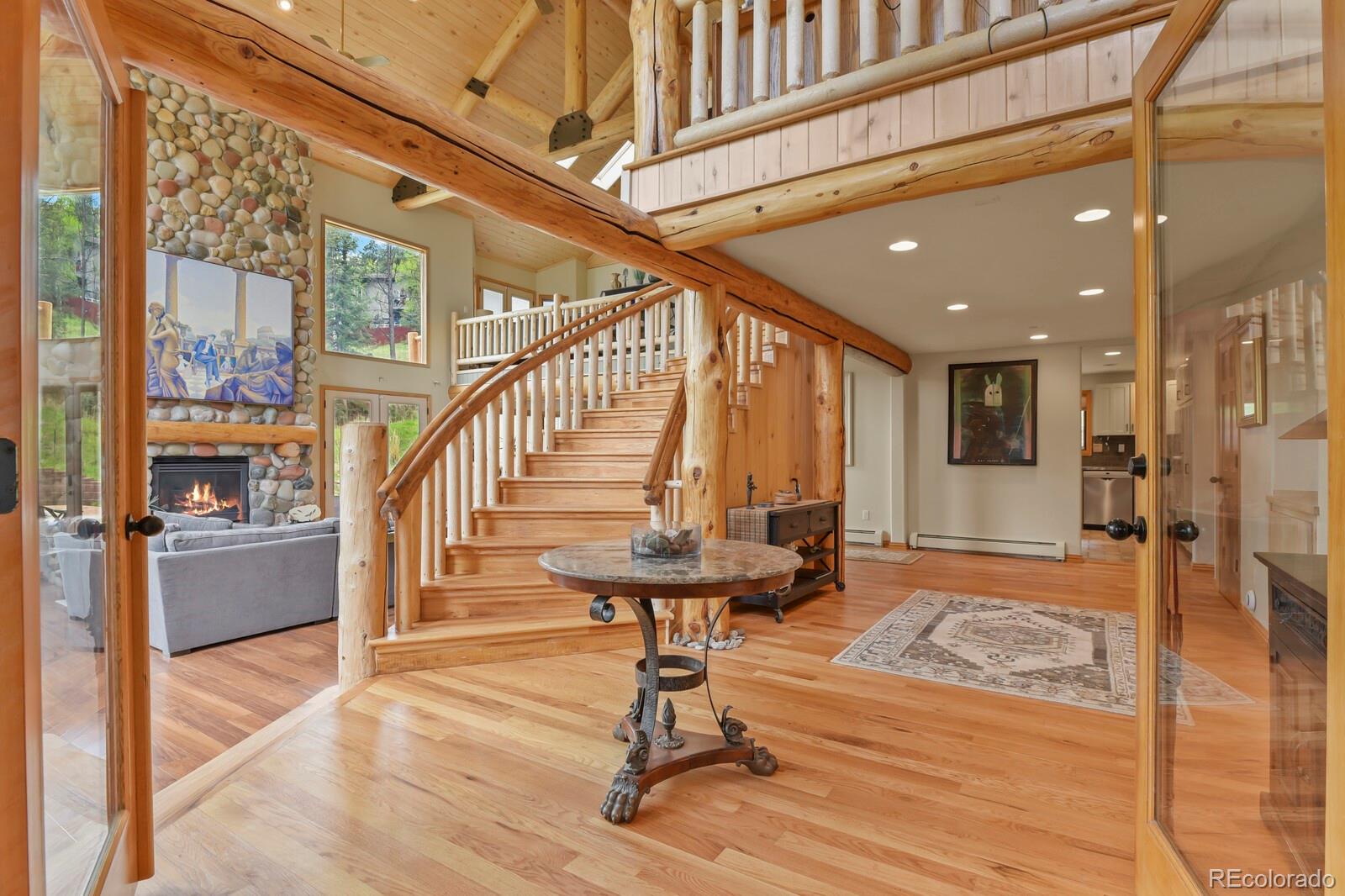 417 Witter Gulch Road Evergreen, CO 80439 - Photo 10 of 50 a view of an entryway with wooden floor and a table