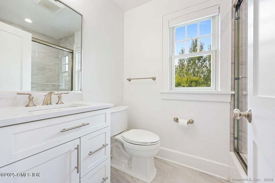 2 Sound View Terrace Greenwich, CT 06830 - Photo 20 of 39 a bathroom with a granite countertop sink a toilet and a mirror
