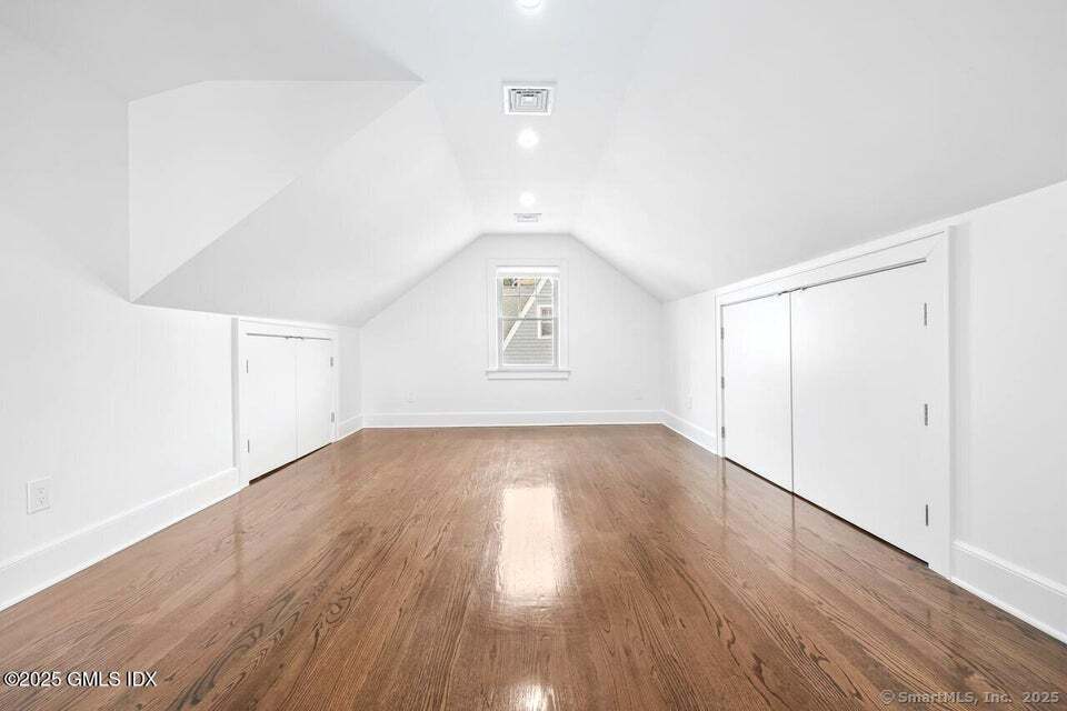 2 Sound View Terrace Greenwich, CT 06830 - Photo 27 of 39 an empty room with wooden floor and windows