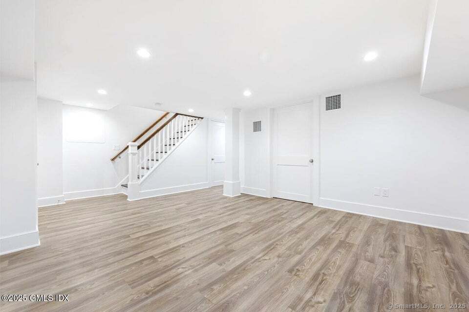 2 Sound View Terrace Greenwich, CT 06830 - Photo 30 of 39 a view of an empty room with wooden floor and stairs