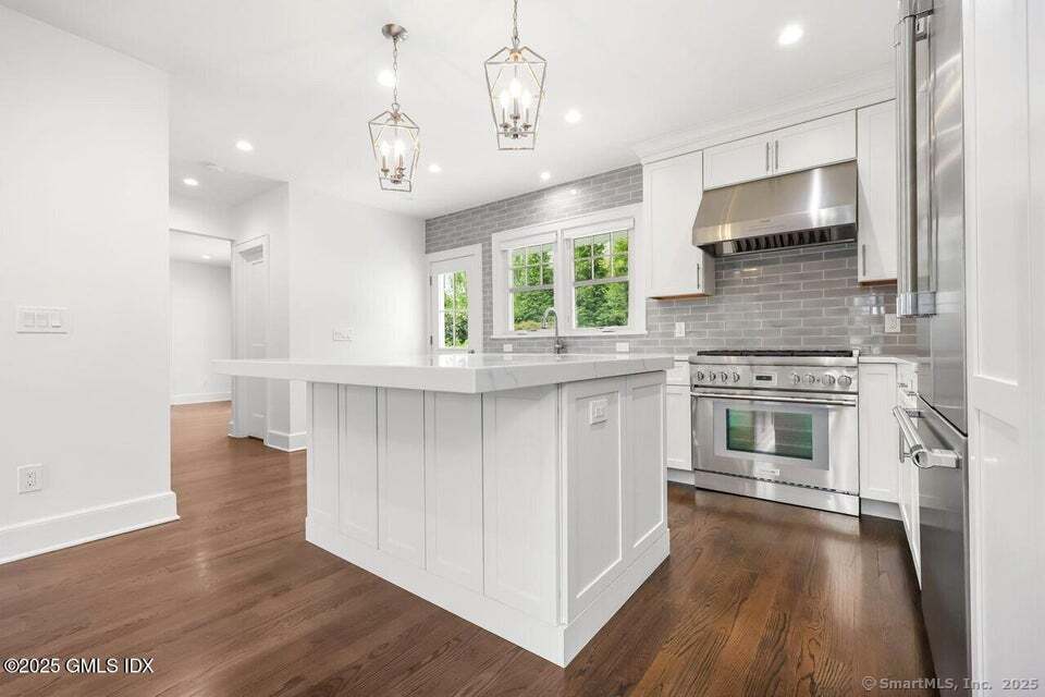 2 Sound View Terrace Greenwich, CT 06830 - Photo 6 of 39 a kitchen with stainless steel appliances a stove top oven and sink