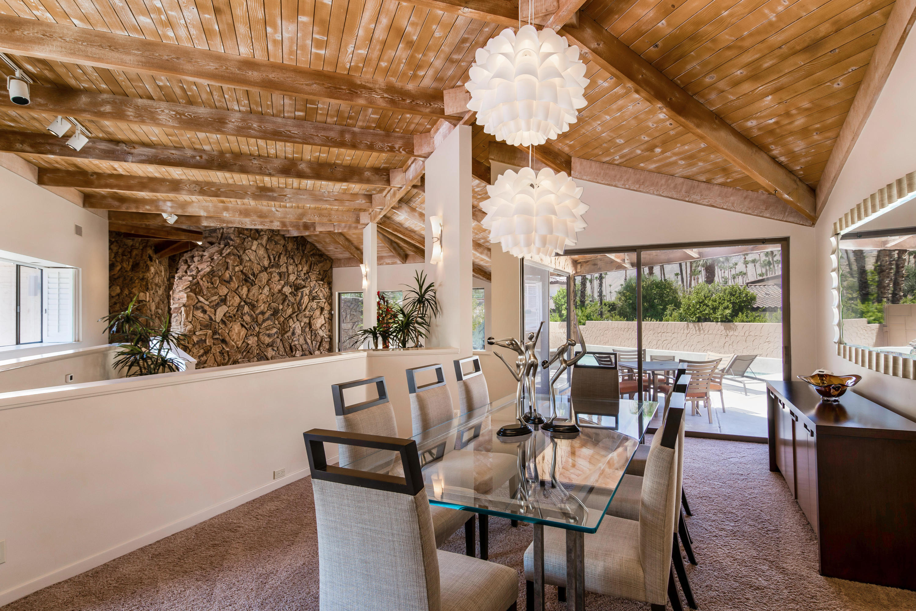 1650 Ridgemore Drive Palm Springs, CA 92264 - Photo 18 of 69 a view of a dining room with furniture large windows and wooden floor