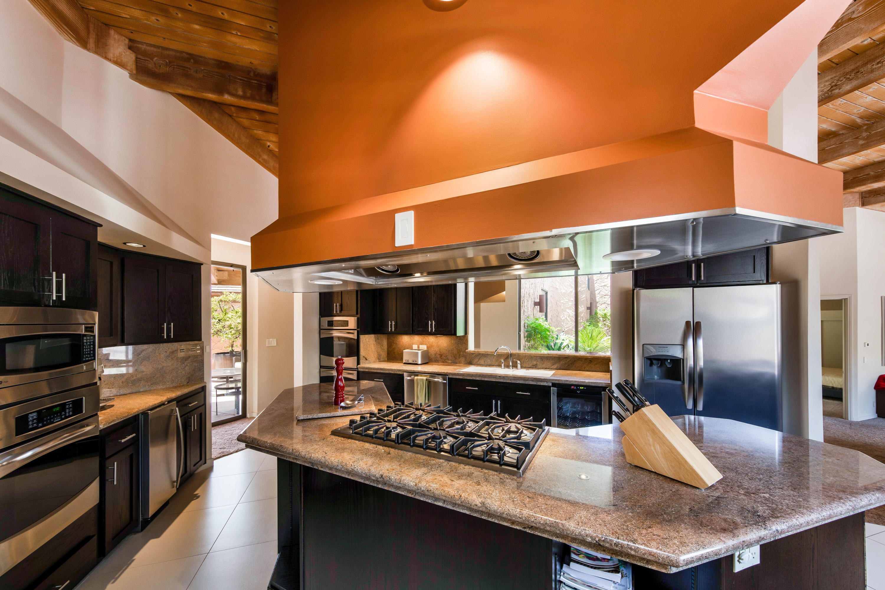 1650 Ridgemore Drive Palm Springs, CA 92264 - Photo 26 of 69 a kitchen with stainless steel appliances granite countertop a sink a stove and a refrigerator