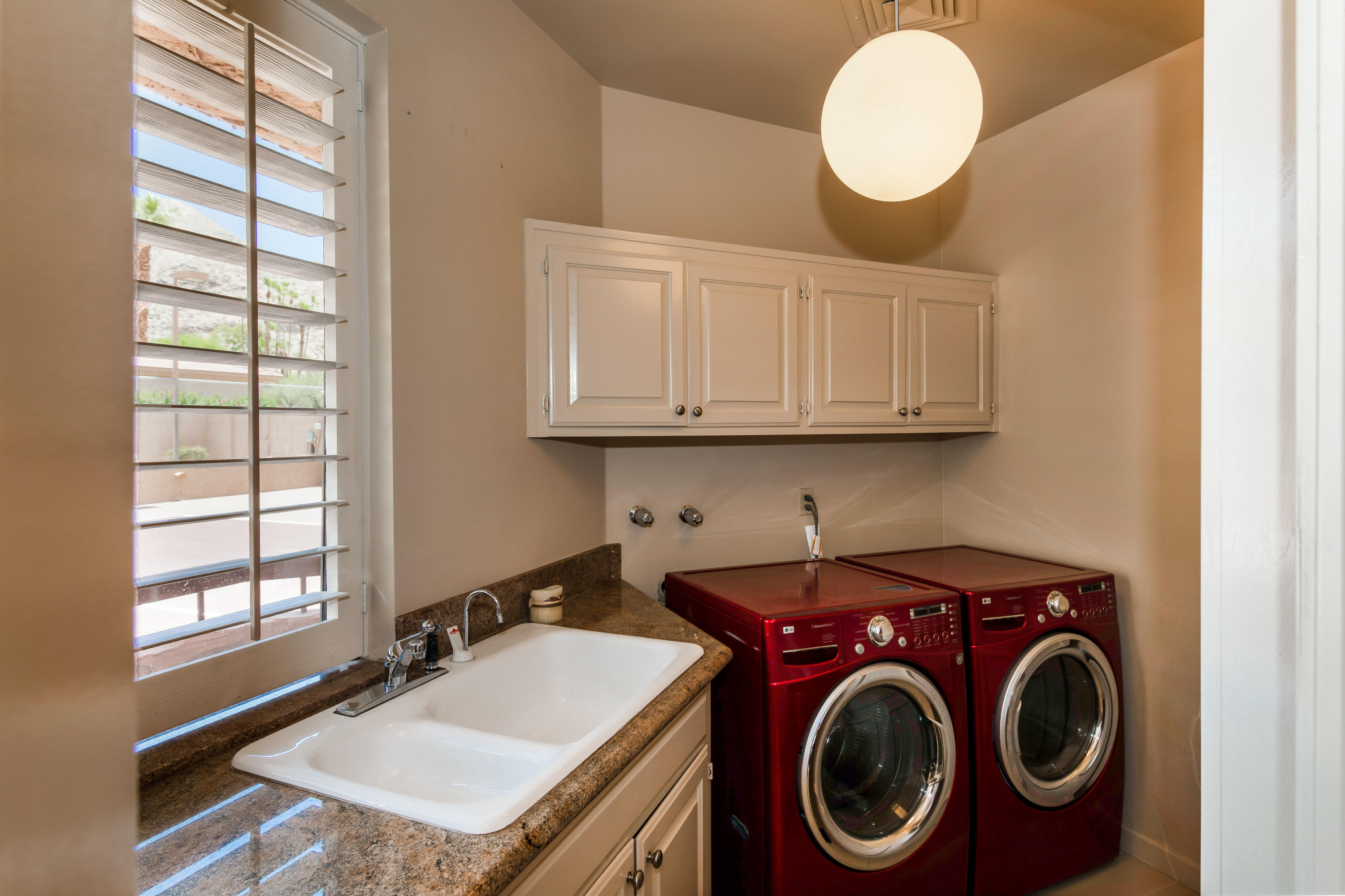 1650 Ridgemore Drive Palm Springs, CA 92264 - Photo 29 of 69 a bathroom with a sink a toilet and a window