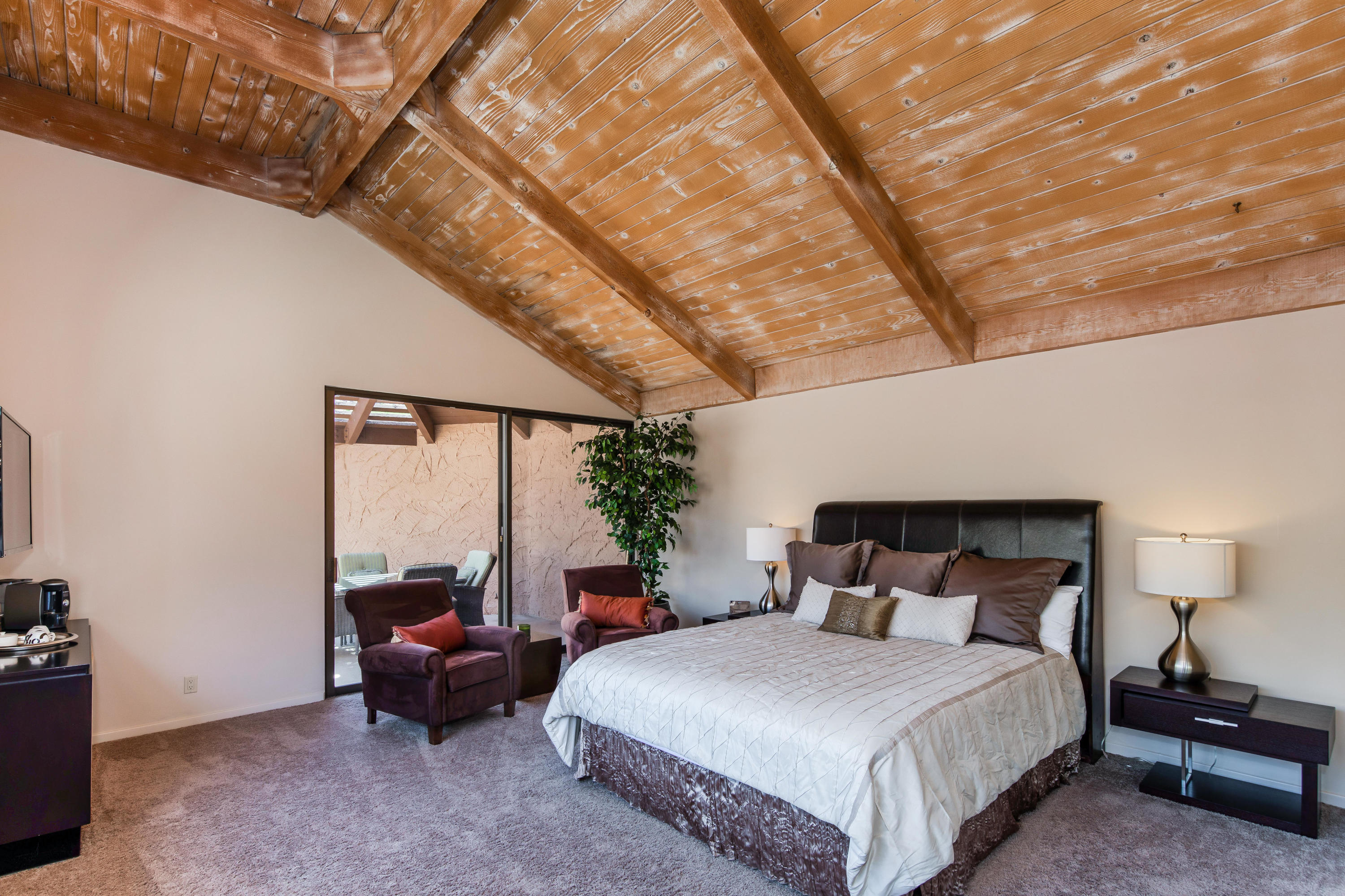 1650 Ridgemore Drive Palm Springs, CA 92264 - Photo 52 of 69 a bedroom with a bed and a potted plant