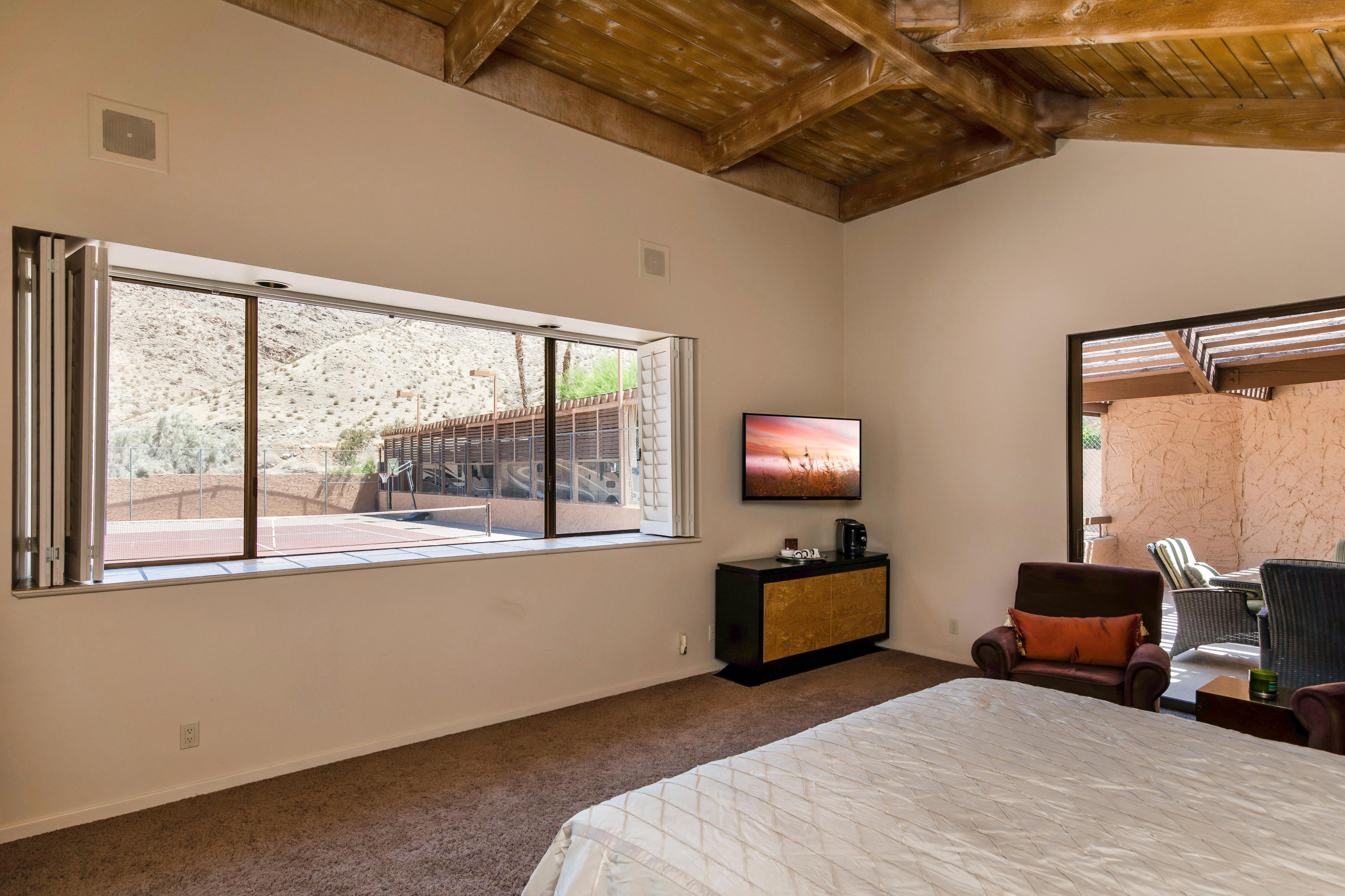 1650 Ridgemore Drive Palm Springs, CA 92264 - Photo 54 of 69 a bedroom with furniture and a flat screen tv
