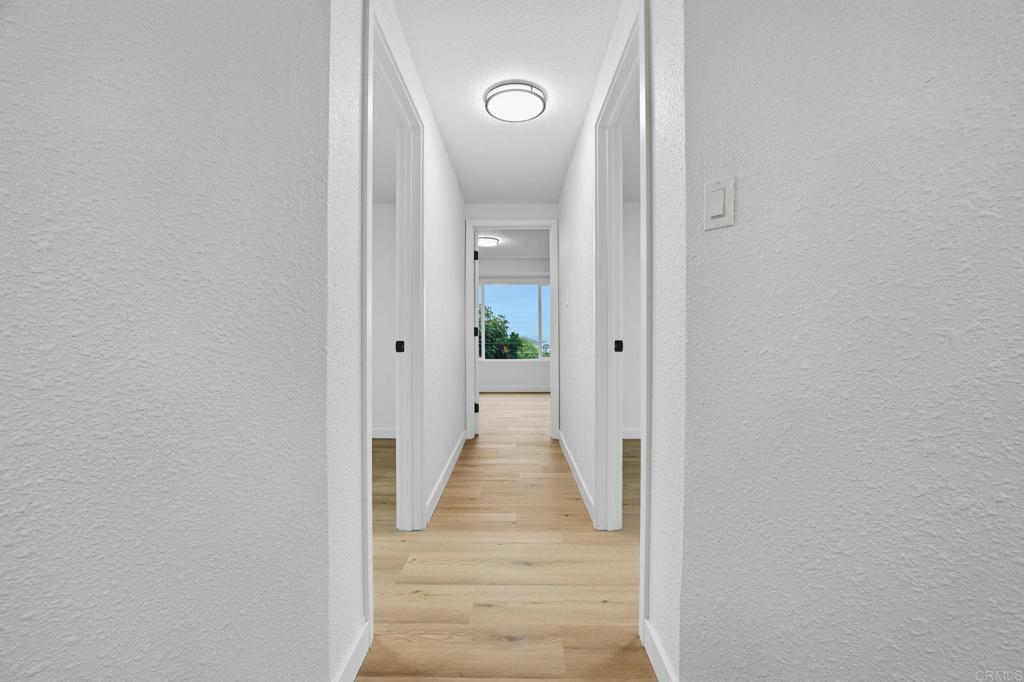 1333 Helix Street Spring Valley, CA 91977 - Photo 24 of 45 a view of a hallway with wooden floor