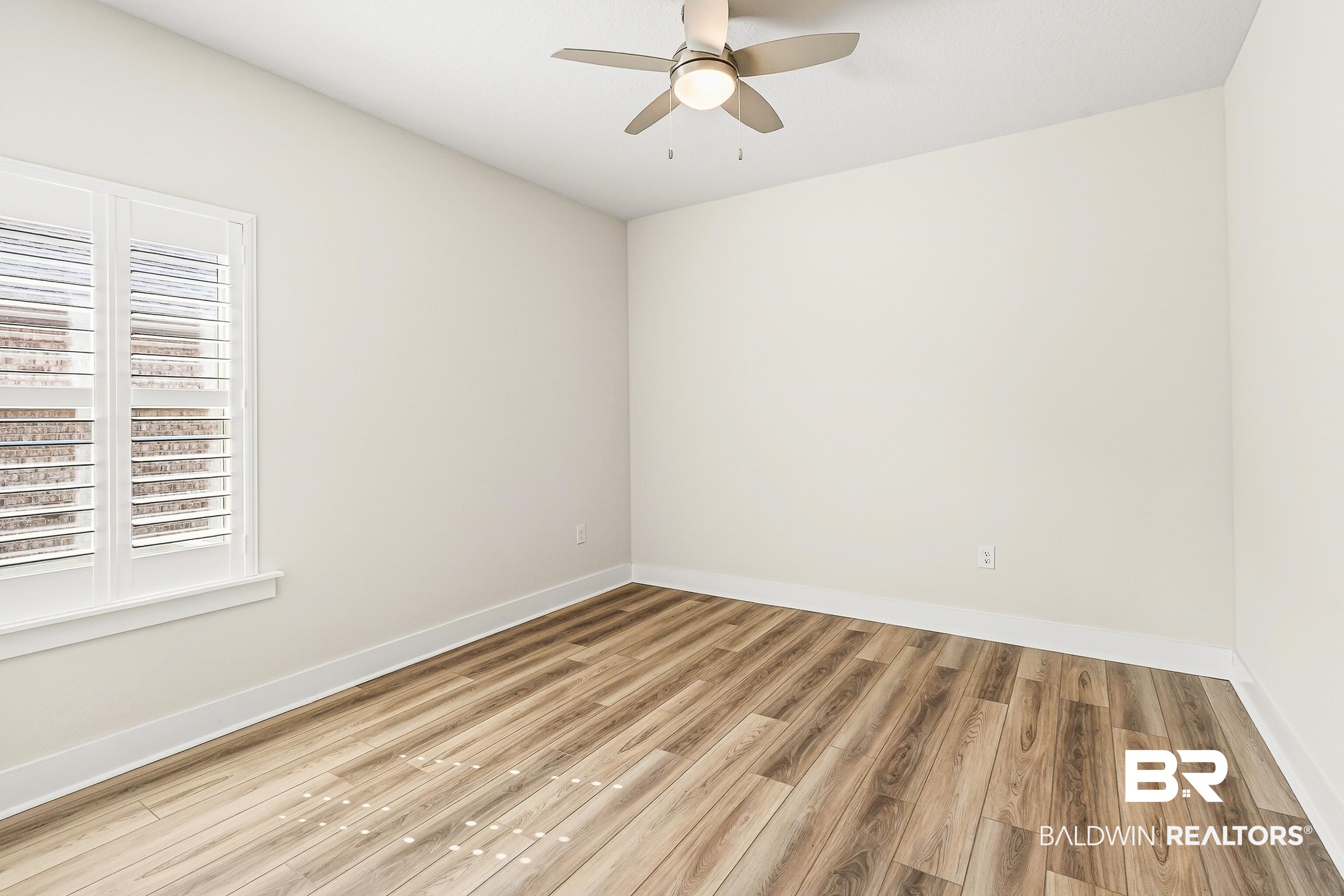 1728 Partridge Street Foley, AL 36535 - Photo 26 of 37 Empty room with wood finished floors and ceiling fan