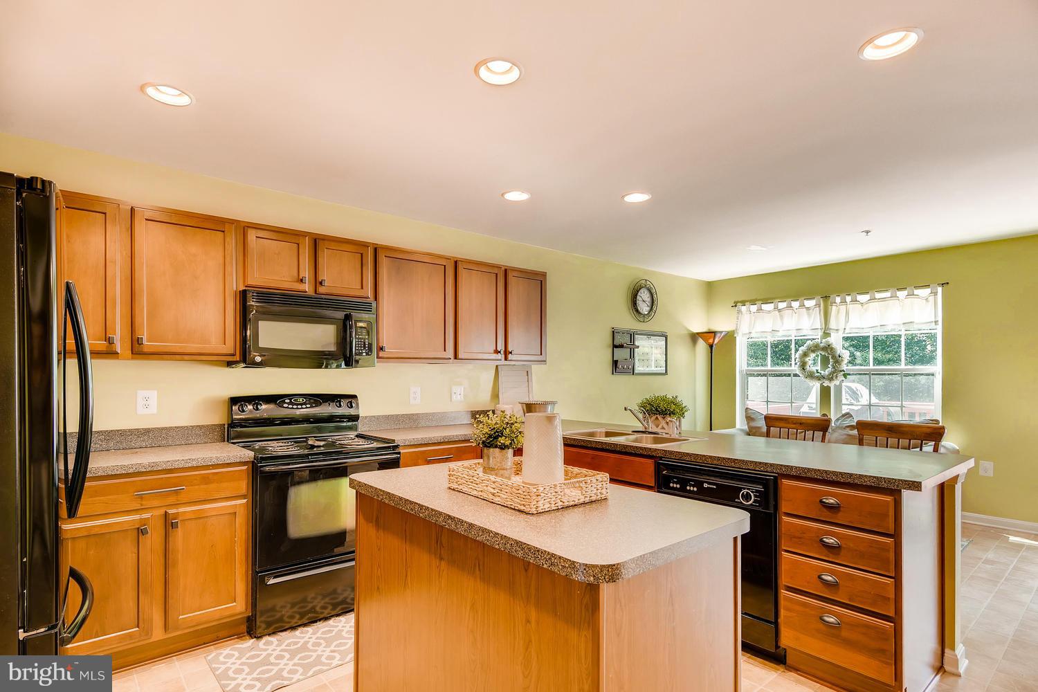 3089 Raking Leaf Drive Abingdon, MD 21009 - Photo 7 of 28 a kitchen with stainless steel appliances a sink stove and refrigerator