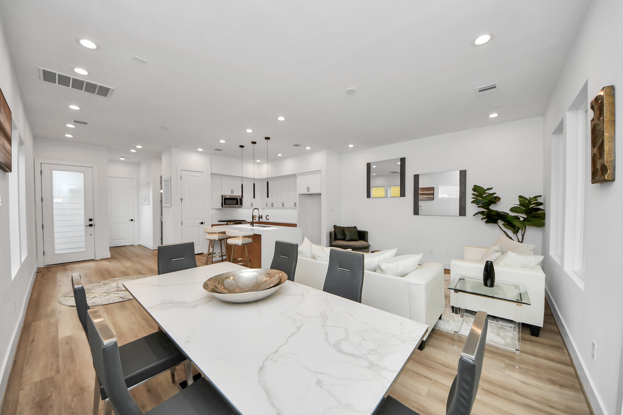 505 Middle Street Houston, TX 77003 - Photo 12 of 46 Discover a sleek, open-concept dining area seamlessly connected to a modern kitchen and cozy living space, perfect for entertaining and everyday comfort.