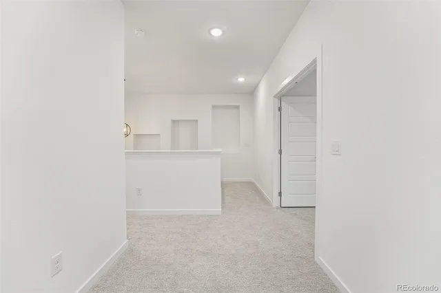 a view of a hallway with white walls