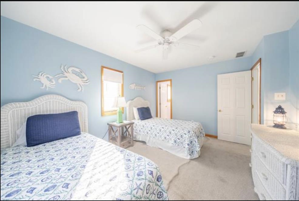141 8th Street Avalon, NJ 08202 - Photo 11 of 21 a bedroom with a large bed and a couch