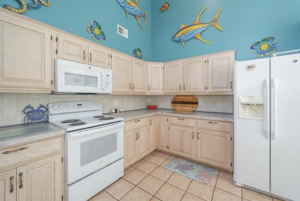 141 8th Street Avalon, NJ 08202 - Photo 14 of 21 a kitchen with granite countertop a white cabinets and white appliances