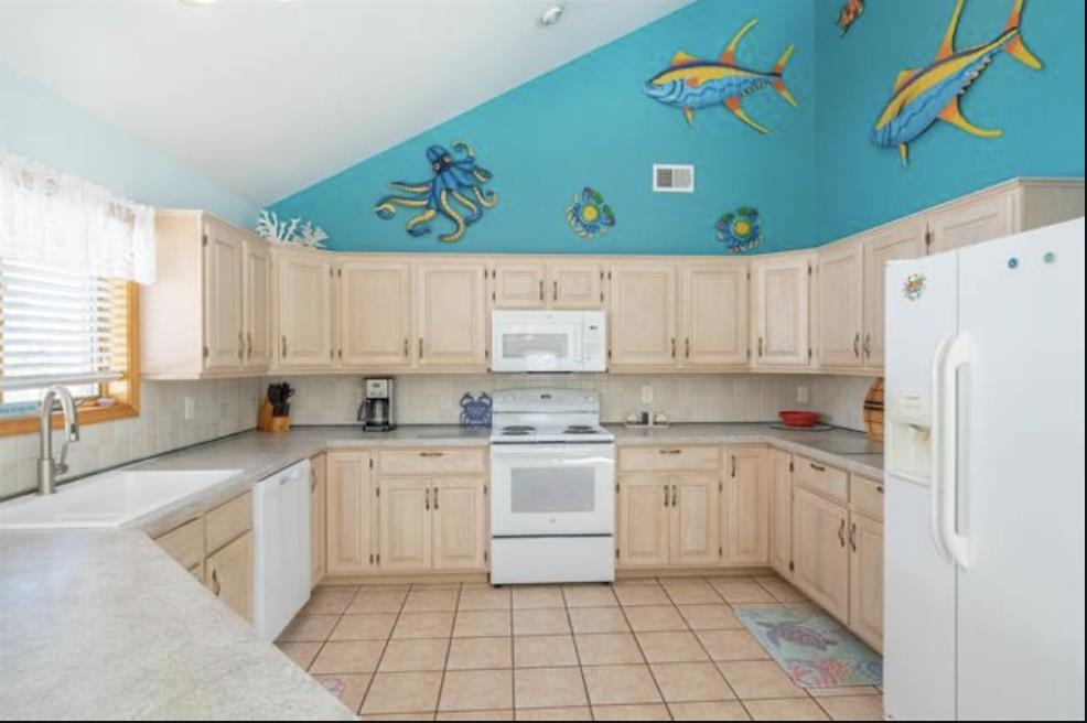 141 8th Street Avalon, NJ 08202 - Photo 15 of 21 a kitchen with cabinets and white appliances