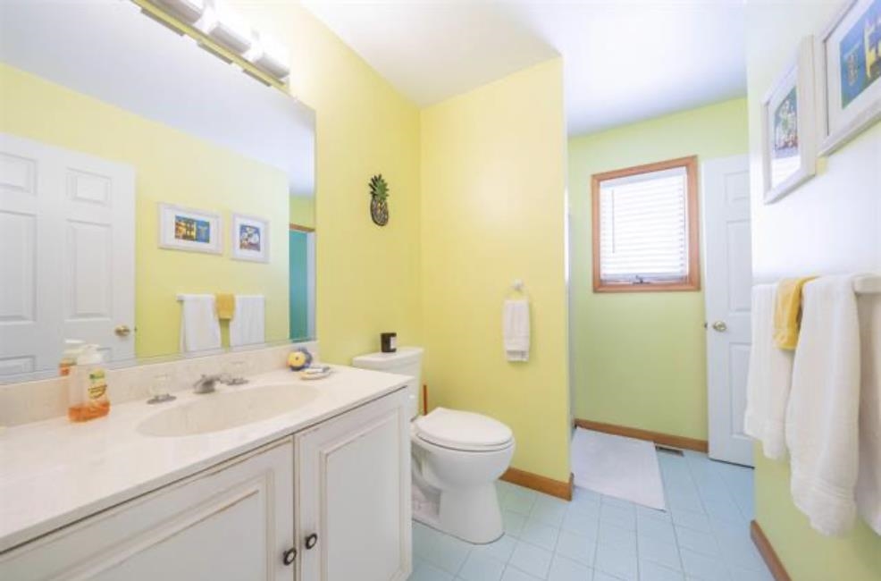 141 8th Street Avalon, NJ 08202 - Photo 2 of 21 a bathroom with a sink a toilet and a large mirror
