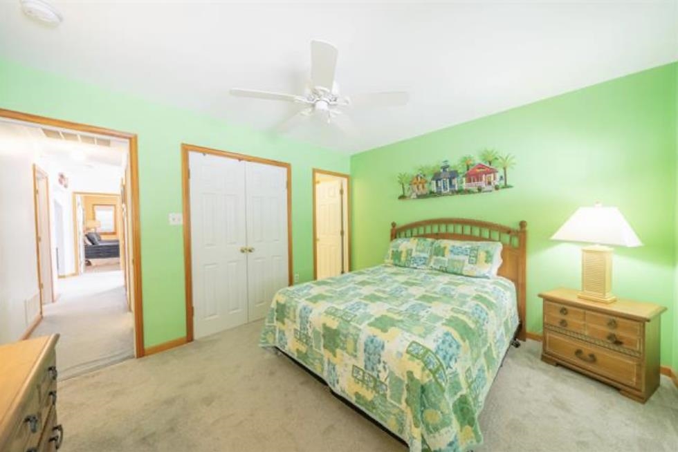 141 8th Street Avalon, NJ 08202 - Photo 3 of 21 a bedroom with a bed and a chandelier