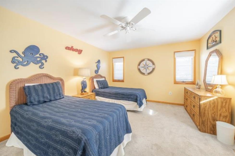 141 8th Street Avalon, NJ 08202 - Photo 7 of 21 a bedroom with a bed and a chandelier