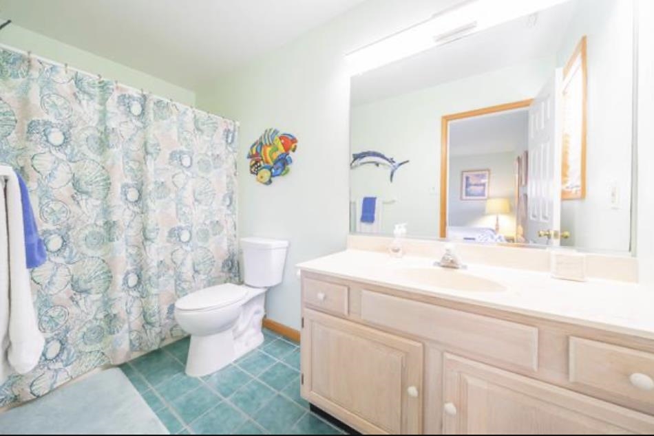 141 8th Street Avalon, NJ 08202 - Photo 9 of 21 a bathroom with a sink a toilet and a mirror