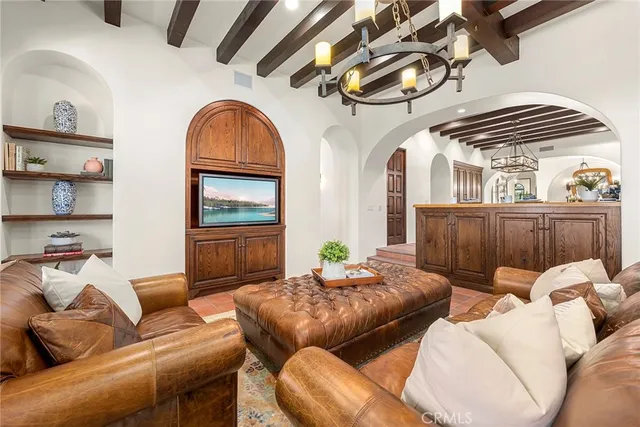 a dining room with furniture a chandelier and wooden floor