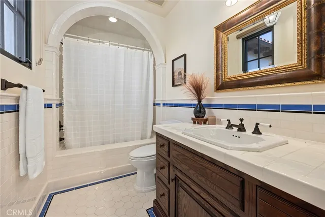 a roof deck with table and chairs and potted plants