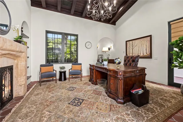 a living room with fireplace furniture and a large window