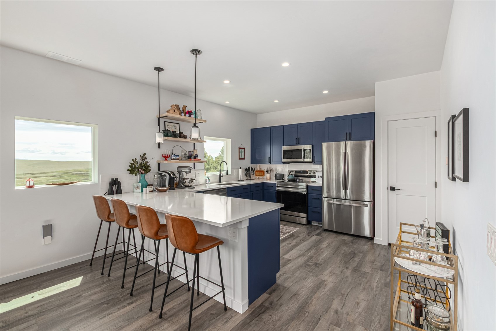 344 Redhill Road Fairplay, CO 80440 - Photo 12 of 44 a kitchen with stainless steel appliances kitchen island granite countertop a dining table chairs and granite counter tops