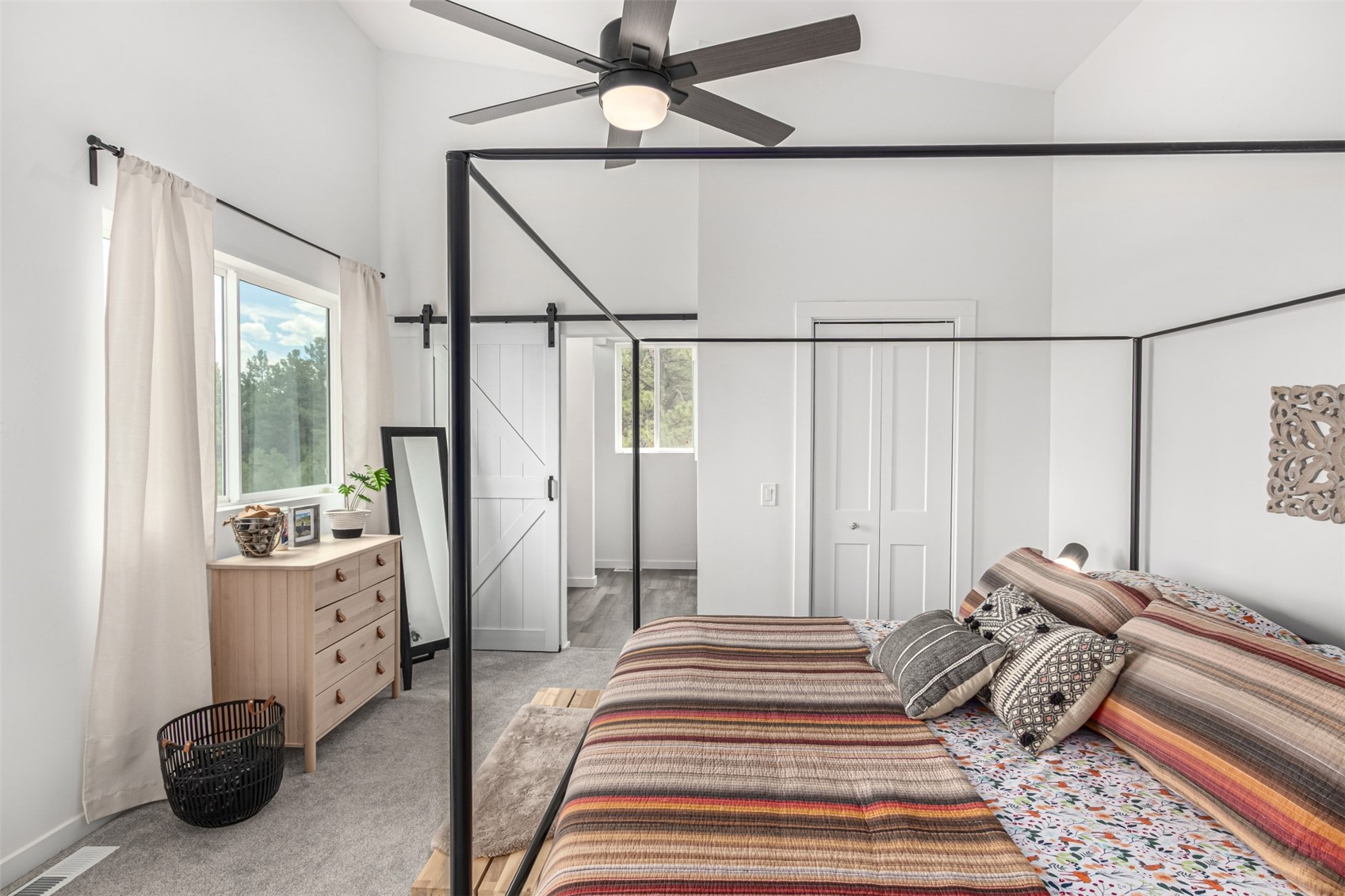 344 Redhill Road Fairplay, CO 80440 - Photo 21 of 44 a bedroom with a bed and a chandelier