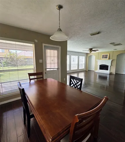 a view of a dining room with furniture and window
