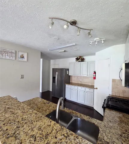 a kitchen with a sink stove and refrigerator