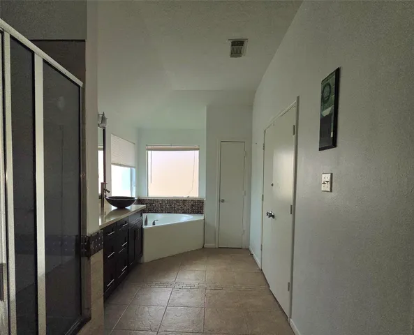 a kitchen with a sink a refrigerator and window
