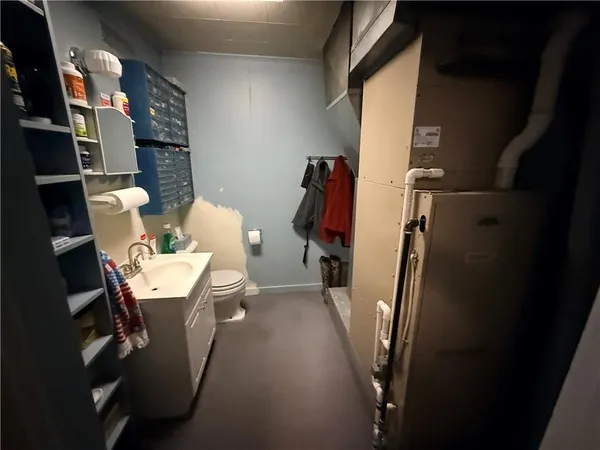 a bathroom with a toilet sink and mirror