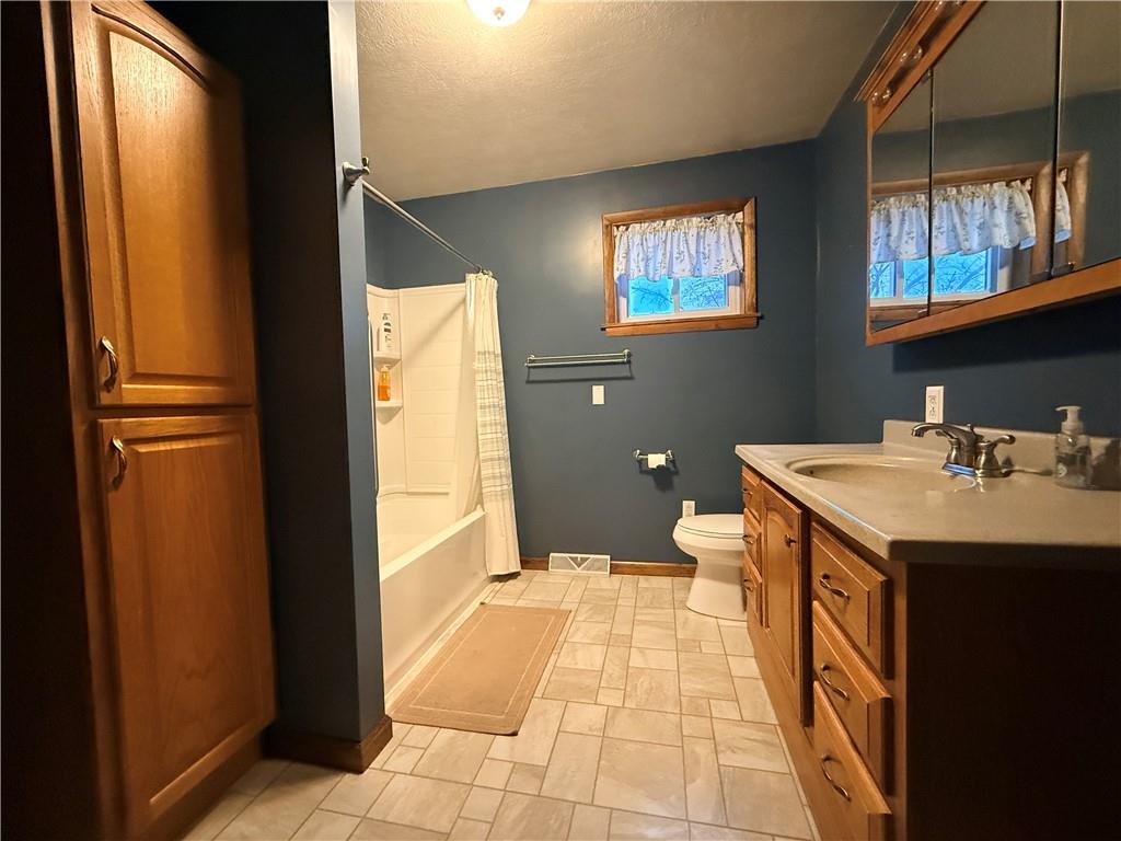 321 Butler Road Kittanning, PA 16201 - Photo 18 of 28 a bathroom with a sink a toilet and a mirror