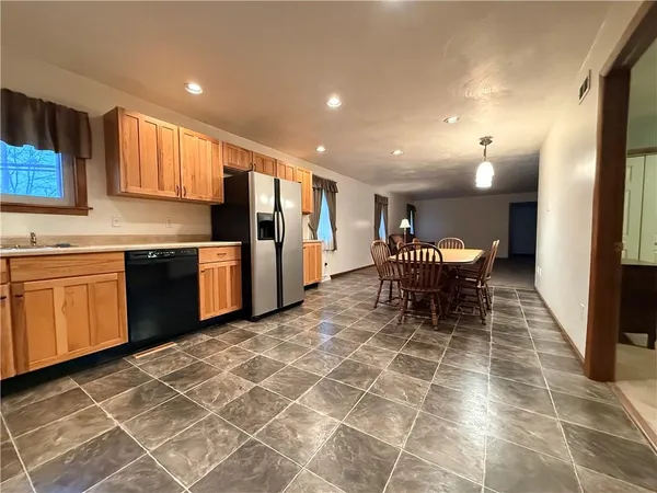 a spacious bedroom with a bed and a chandelier