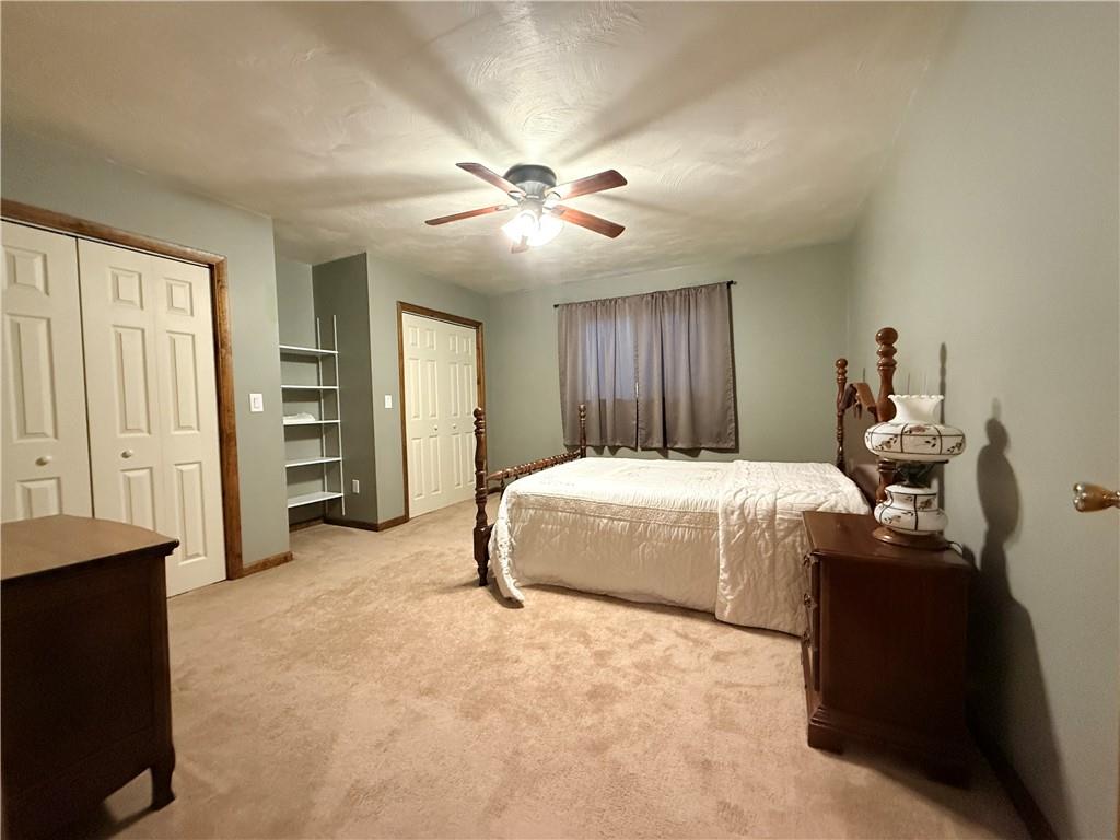 321 Butler Road Kittanning, PA 16201 - Photo 20 of 28 a spacious bedroom with a bed and a chandelier