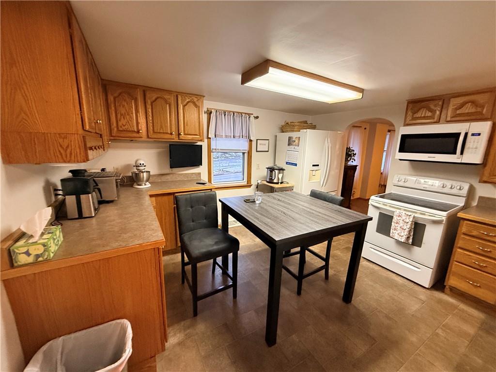 321 Butler Road Kittanning, PA 16201 - Photo 24 of 28 a kitchen with a table chairs and a refrigerator