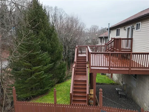 a view of a roof deck with wooden fence and floor