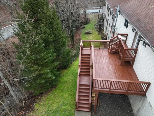 a view of balcony with wooden floor and fence
