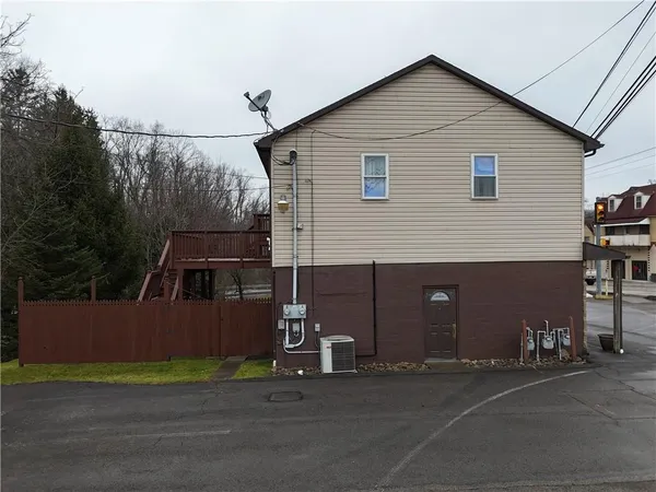 a view of a house with a yard and garage