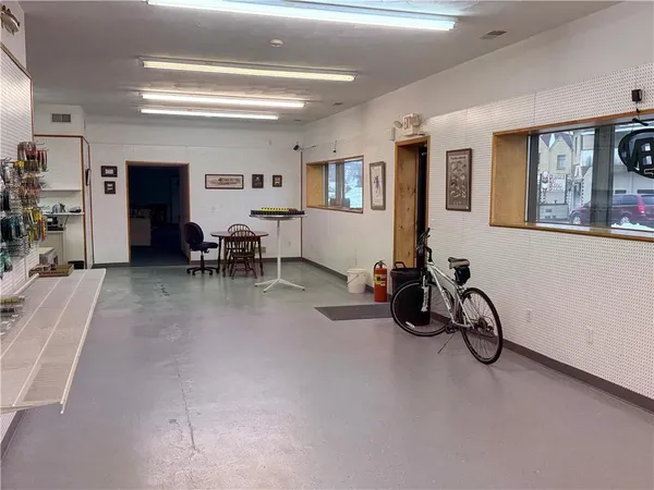 a living room with furniture a window and gym equipment