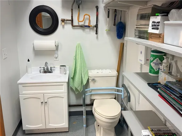 a bathroom with a toilet sink and mirror