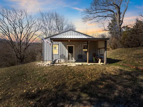 a view of a house with backyard porch and garden