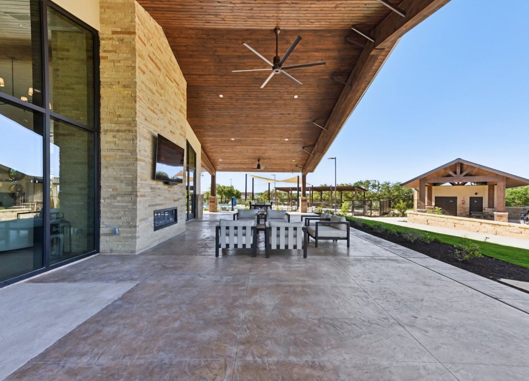 328 Buckaroo Drive Georgetown, TX 78633 - Photo 4 of 9 a view of a terrace with chairs and a table