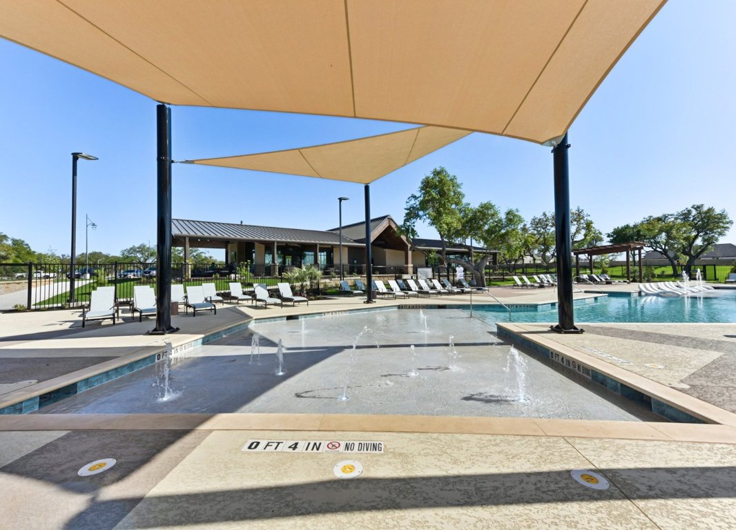 328 Buckaroo Drive Georgetown, TX 78633 - Photo 6 of 9 a view of a patio with a table and chairs under an umbrella