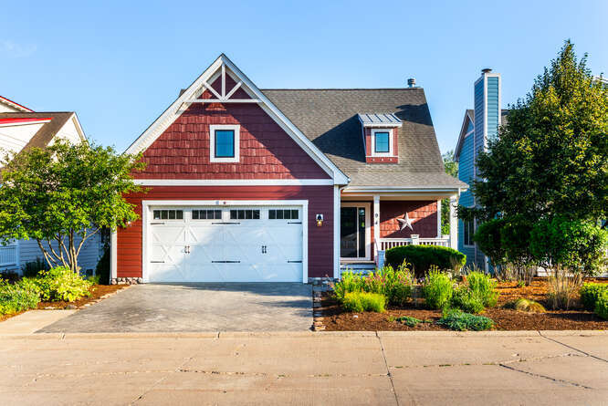 a front view of a house with a garden