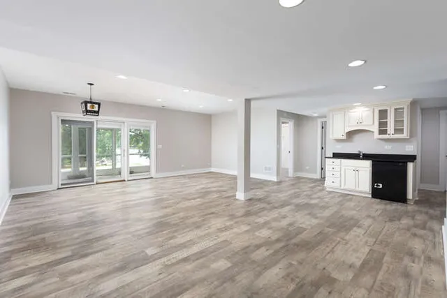 a kitchen with granite countertop a stove a sink and a refrigerator