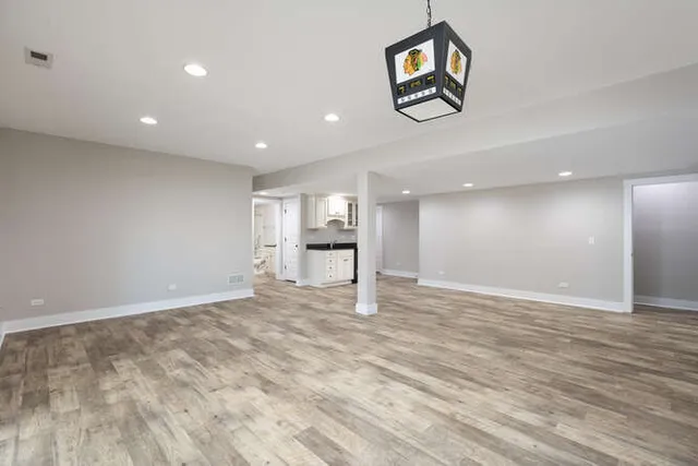 a bathroom with a granite countertop sink toilet a mirror and shower