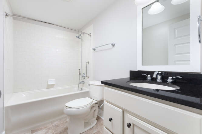 9 Windward Way Ottawa, IL 61350 - Photo 43 of 56 a bathroom with a granite countertop sink toilet a mirror and shower