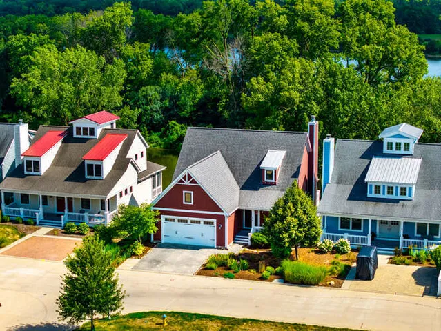 an aerial view of a house with pool garden and trees