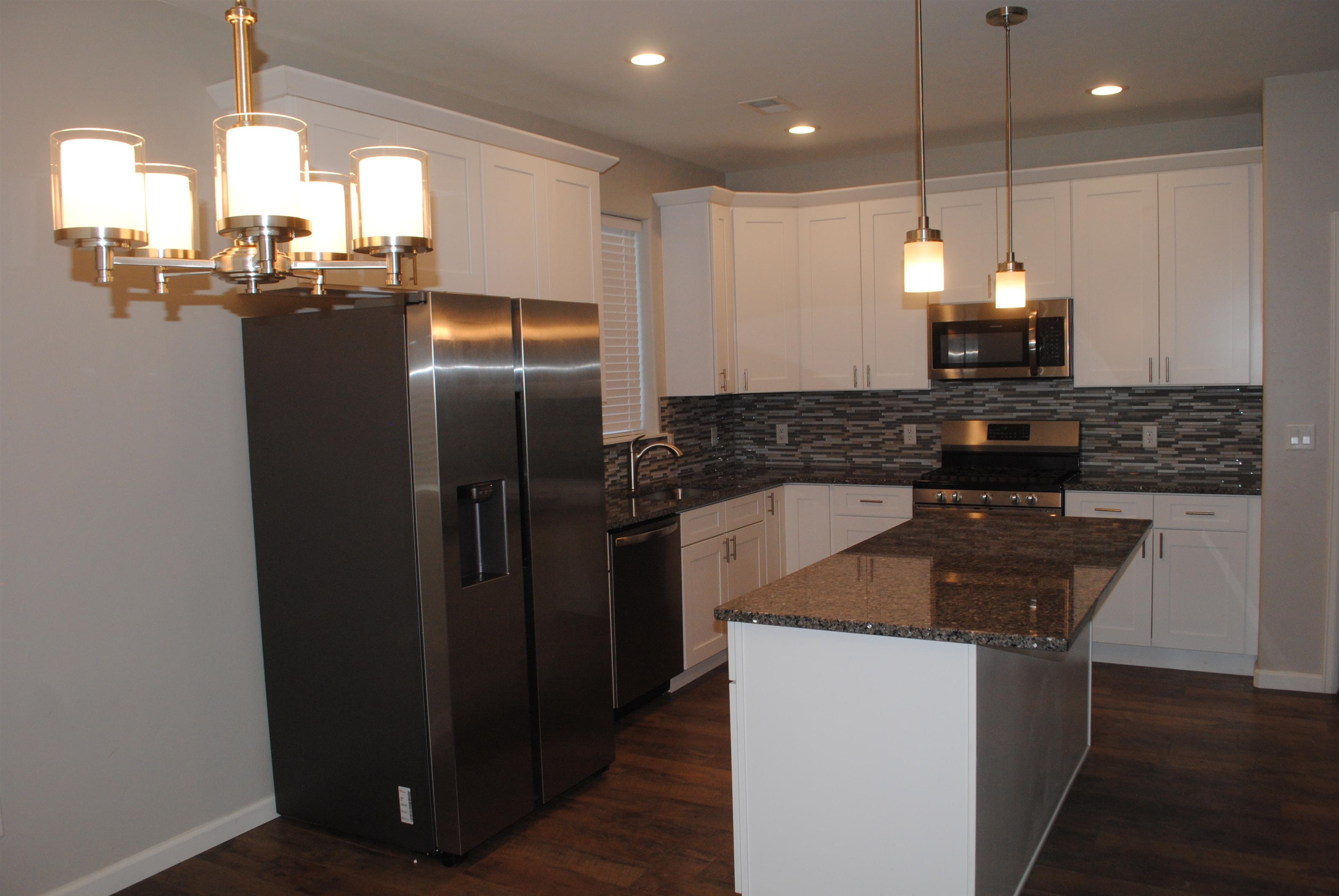 454 Lewis Street Grand Junction, CO 81504 - Photo 14 of 20 a kitchen with stainless steel appliances granite countertop a refrigerator a sink and a stove