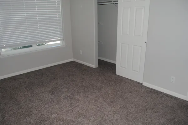 a view of a livingroom with an empty space and a window